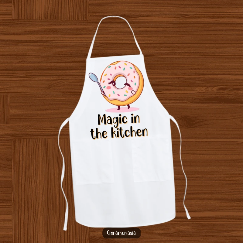 Funny apron showcasing a winking donut with sprinkles, magically levitating a small spoon, ready for kitchen magic.