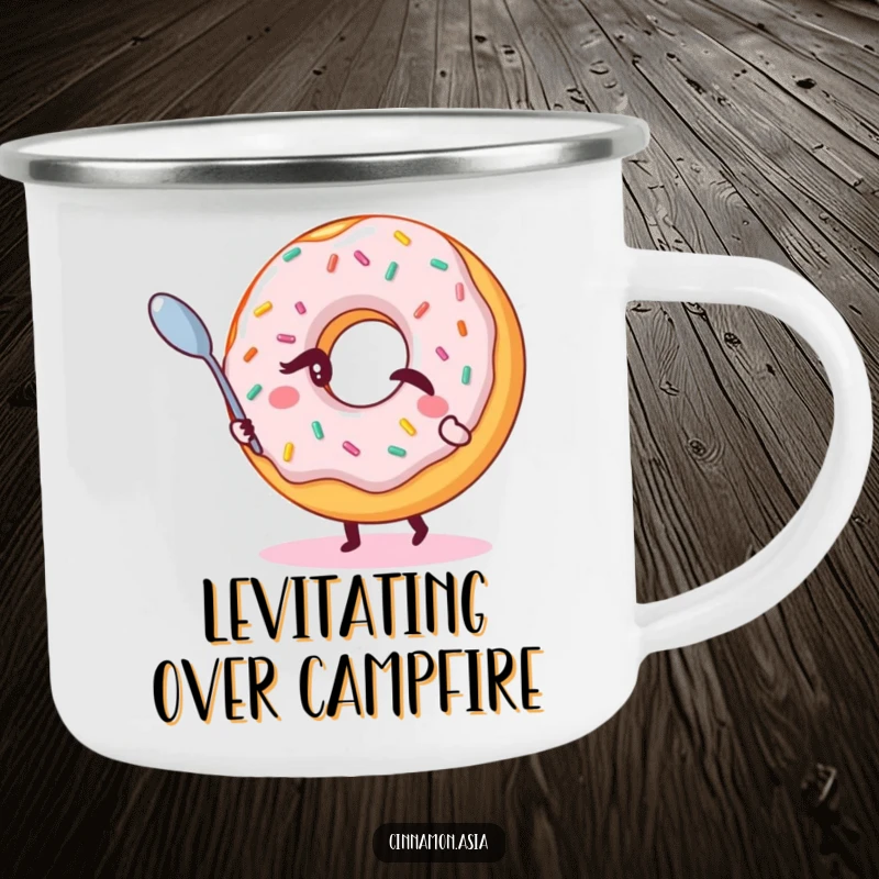 Funny camping mug featuring a winking donut with sprinkles, magically levitating a small spoon, ready for the outdoors.