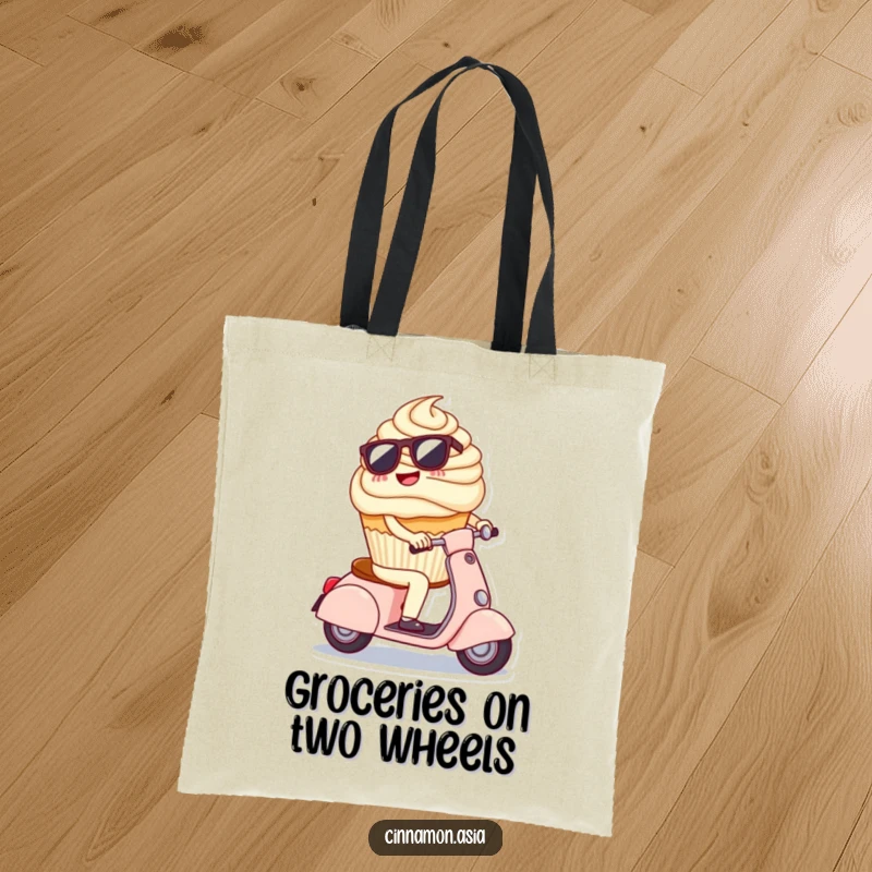 Funny tote bag depicting a cheerful cupcake wearing sunglasses, riding a small scooter with a sunny disposition.